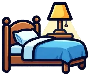 A bed with a blue blanket next to a lamp